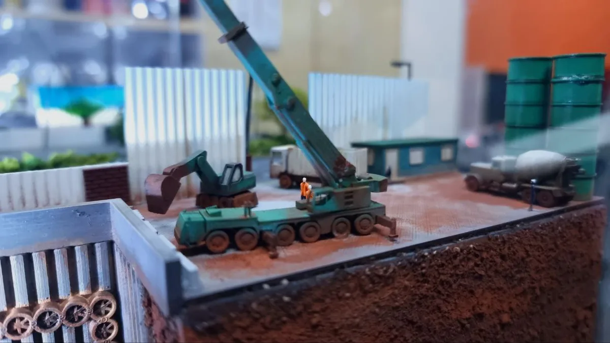Painted construction-site diorama with crane and excavator